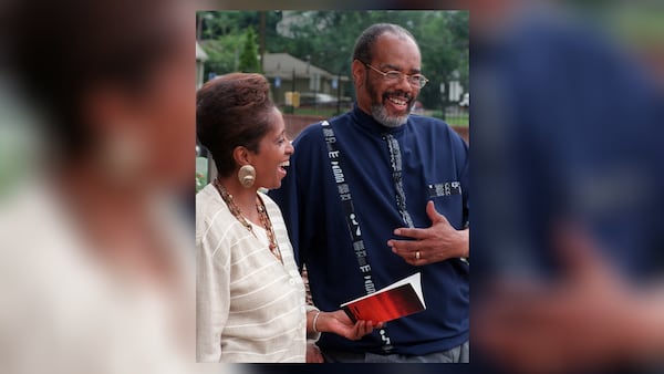 In this 1998 AJC file photo, George Napper is shown with Clark Atlanta University official Doris Weathers, who is holding a volume of Napper's poetry. The former Atlanta police chief died Friday, Oct. 2, 2020, at age 81.