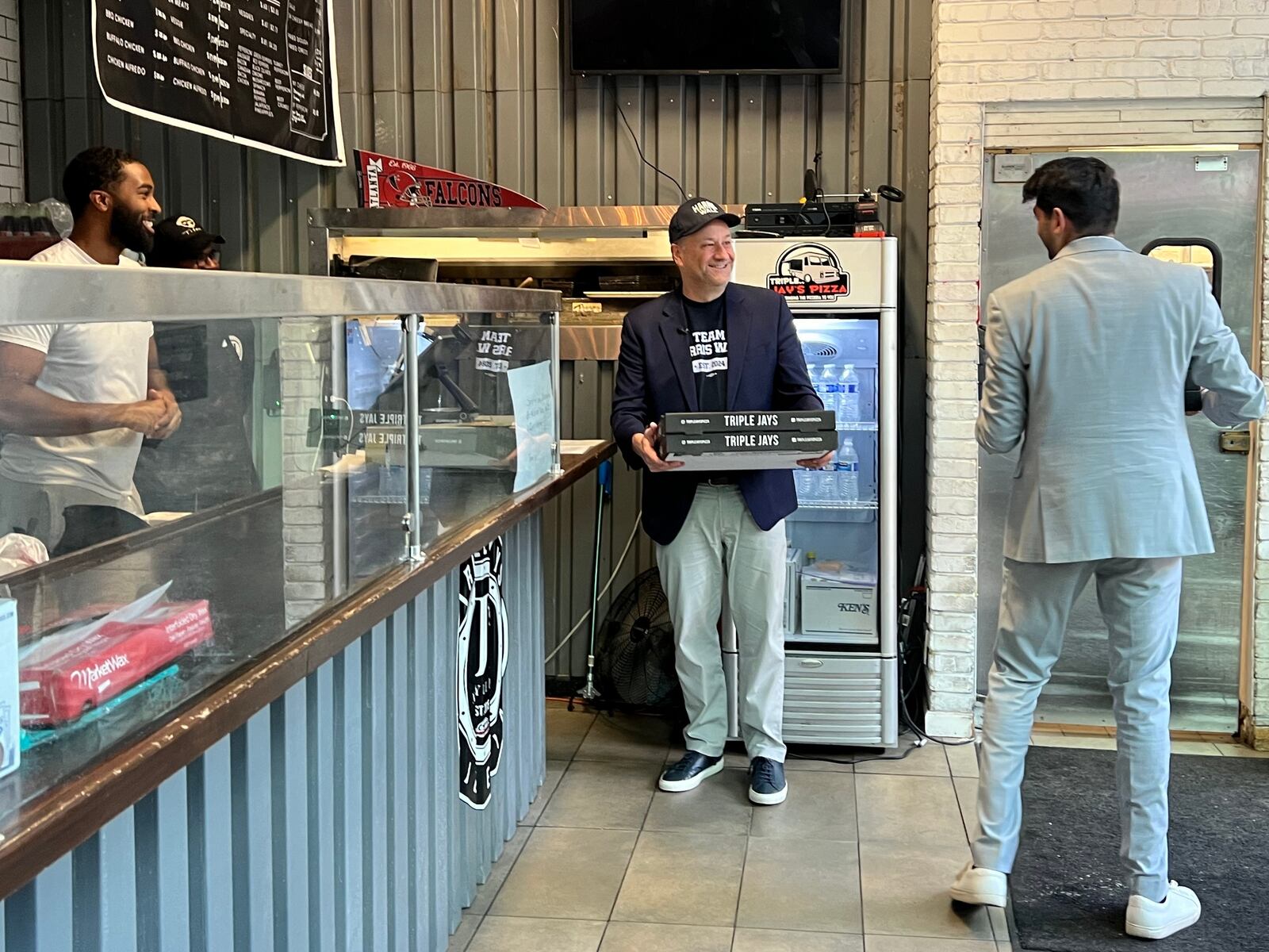 Doug Emhoff takes out four cheese and two pepperoni pizzas at Triple Jays Pizza Bar in midtown Atlanta on October 27, 2024.