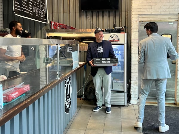 Doug Emhoff takes out four cheese and two pepperoni pizzas at Triple Jays Pizza Bar in midtown Atlanta on October 27, 2024.