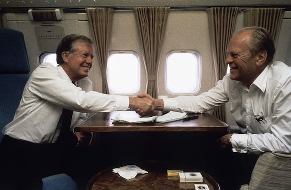 President Jimmy Carter enjoys a friendly exchange with former President Gerald Ford aboard Air Force 1 between Cairo and Spain on Oct. 10, 1981.