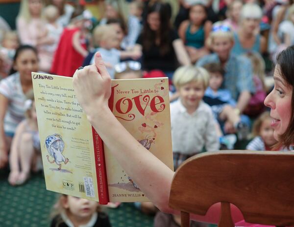 Children’s librarian Samantha Merigold reads Never Too Little To Love to young children and their families during a special Preschool Story Time Valentines Day celebration at the Society of the Four Arts, Monday, February 12, 2018. After listening to Valentines Day themed stories and singing, children were invited to create a Valentine’s mailbox, have a Valentine exchange party, and then enjoy lunch in the “Cupid Cafe.” Damon Higgins / The Palm Beach Post