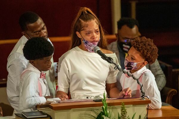 07/15/2020 - Atlanta, Georgia - Charmaine Turner, center, mother of Secoriea Turner, is surrounded by her sons and Secoriea's father, Secoriey Williamson, second from left, as she becomes emotional while reciting a poem during the homegoing service for Secoriea at New Calvary Missionary Church in Atlanta's Sylvan Hills community on Wednesday, July 15, 2020. On July 4, 8-year-old Secoriea was shot dead near the Wendy's in Atlanta's Peoplestown community. She was one of five individuals who were killed over the Independence Day weekend in Atlanta. (ALYSSA POINTER / ALYSSA.POINTER@AJC.COM)