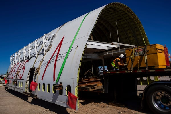 A section of a 747 airplane moves through Las Vegas streets on the way to a new home at Area 15 where it will be part of an immersive art display, on Wednesday, Feb. 26, 2025. (AP Photo/Ty ONeil)