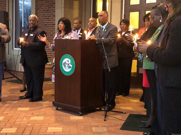 Stockbridge Mayor Anthony Ford speaks at candlelight prayer vigil Monday at Stockbridge City Hall.