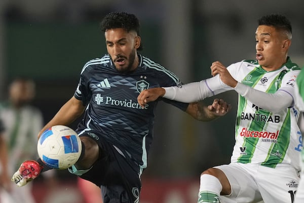 FILE - Seattle Sounders Jesus Ferreira, left, plays the ball as Antigua GFC's Oscar Santis closes in during a CONCACAF Champions Cup soccer match at Pensativo stadium in Antigua, Guatemala, Wednesday, Feb. 19, 2025. (AP Photo/Moises Castillo, File)