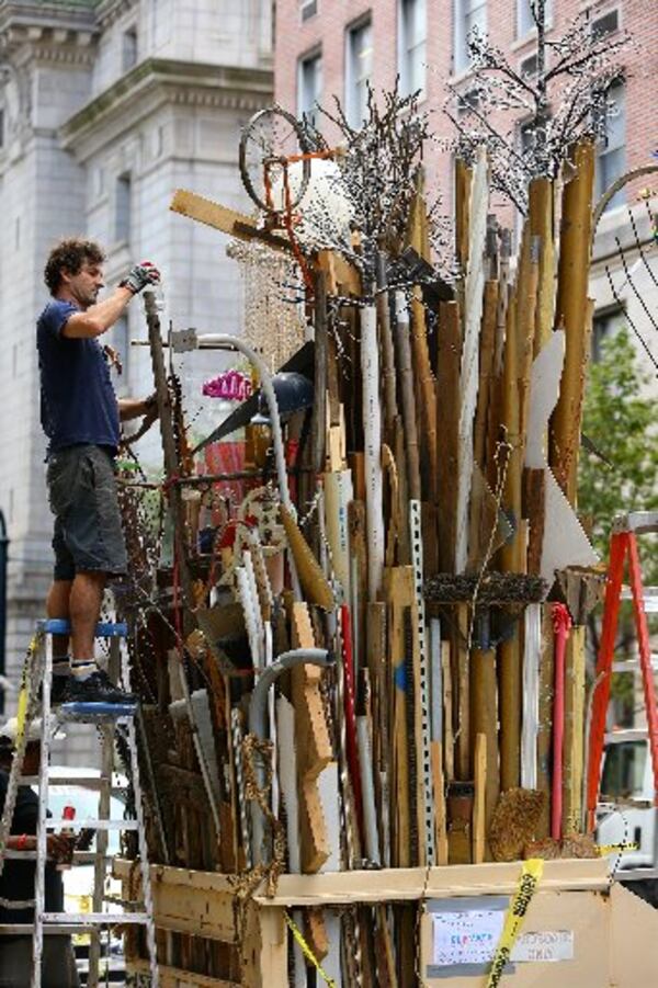 Savannah artist Marcus Kenney transforms a dumpster into a visual arts environment called “Timeline” using objects of previous existence on Forsyth Street downtown. The “Dumpsters” project, involving more than 20 artists that have been given 10 metal trash receptacles to create a work of public art, will be part of this year’s “Elevate.” The Office of Cultural Affairs’ free weeklong public art event runs Oct. 17-23. CURTIS COMPTON / CCOMPTON@AJC.COM