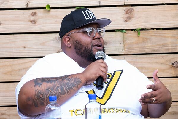 July 13, 2020, Atlanta — Lorenzo Lewis, left, talks at a meeting organized by "The Confess Project." The organization, founded by Lewis, enlists barbershops like Privado to double as mental health centers, where Black men can comfortably talk about their issues. (RYON HORNE/RHORNE@AJC.COM)