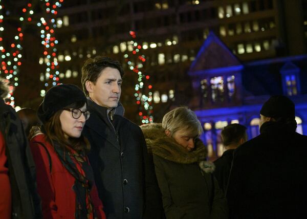 Canadian Prime Minister Justin Trudeaux, second from left, stands among mourners attending a candlelight vigil held Wednesday, Feb. 20, 2019, in Halifax, Nova Scotia, for seven Syrian refugee children killed in a fire at their home in the Spryfield community of Halifax the day before. The children’s parents, Ebraheim and Kawthar Barho, who sought refuge for their family in September 2017, survived the fire, but Ebraheim Barho suffered life-threatening injuries when he went back into the burning home in an attempt to save the children, ages 14 to 4 months.