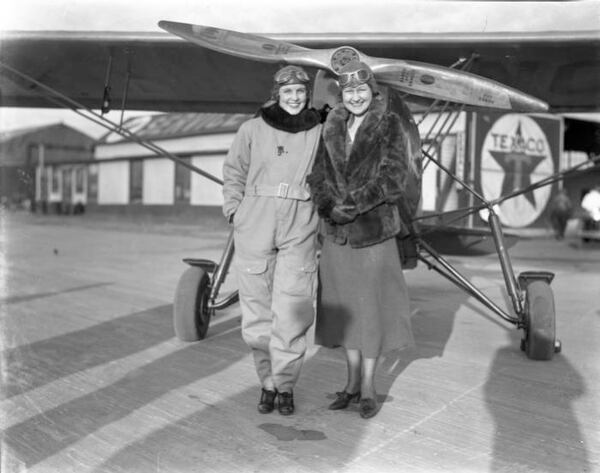 Atlanta pilots Madeline Johnson and Ruth Mohr pose at Candler Field during an event in 1934. The two were scheduled to fly to Miami in Johnson's plane later that day, in order to take part in an event called the All-American Air Race. Their flight to Miami was to be the longest ever made by an Atlanta aviatrix. (AJC Archive at GSU Library AJCN030-070m)