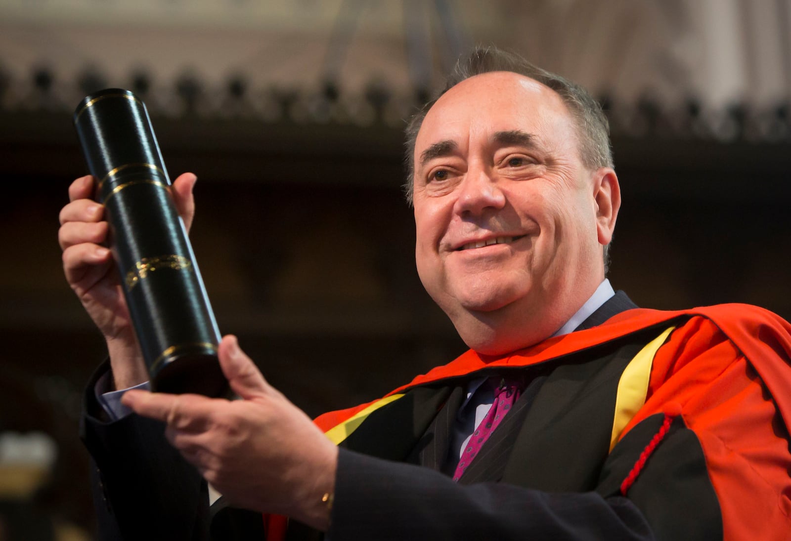 FILE - Alex Salmond holds his honorary degree awarded to him by Glasgow University on April 4, 2021. (Danny Lawson/PA via AP)