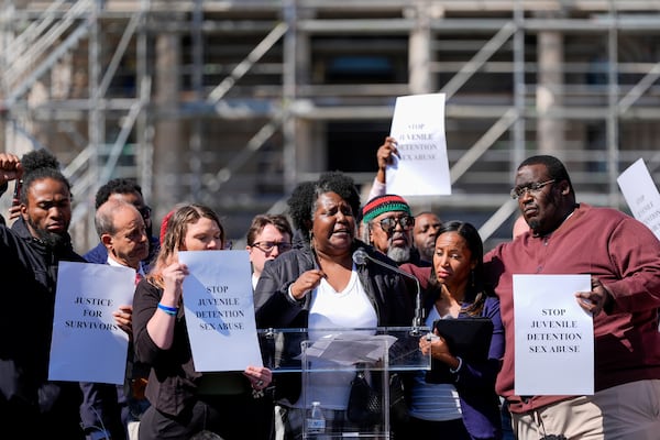 Nalisha Gibbs, center, becomes emotional while speaking during a press conference among other survivors of sexual abuse in Maryland juvenile detention centers, Wednesday, March 19, 2025, in Baltimore. (AP Photo/Stephanie Scarbrough)