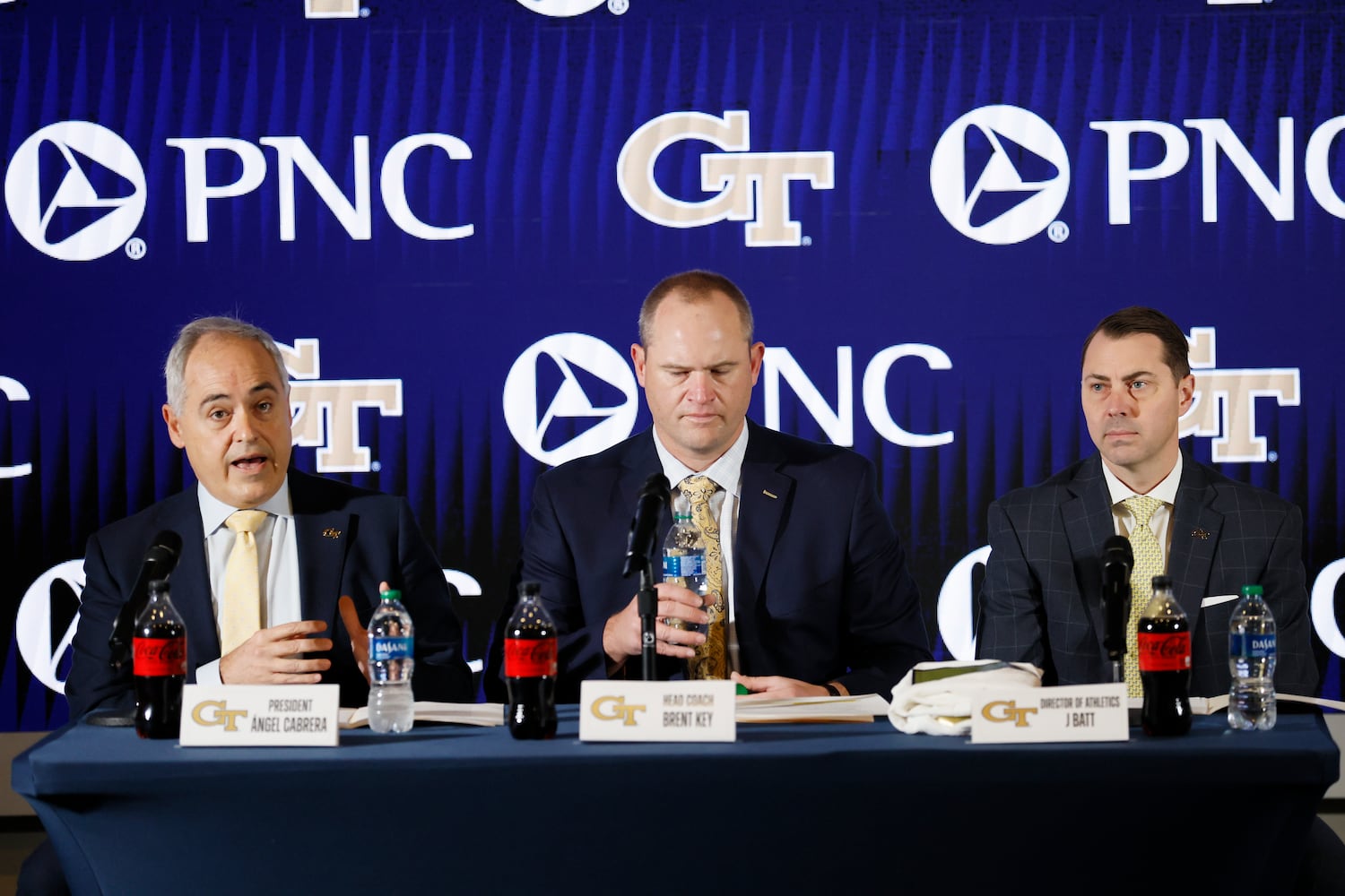 Georgia Tech President Ángel Cabrera (left) and athletic director J Batt (right) introduce the new football head coach Brent Key during a press conference on Monday, Dec. 5, 2022.
 Miguel Martinez / miguel.martinezjimenez@ajc.com