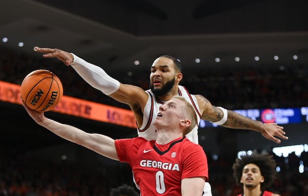 Auburn forward/center Johni Broome (4) blocks a shot by Georgia guard Blue Cain (0) during the first half an NCAA college basketball game Saturday, Feb. 22, 2025, in Auburn, Ala. (AP Photo/Julie Bennett)