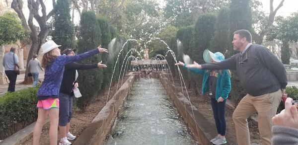 The Wade family tosses Jerry’s ashes into a fountain on the island of Majorca off the coast of Spain. CONTRIBUTED