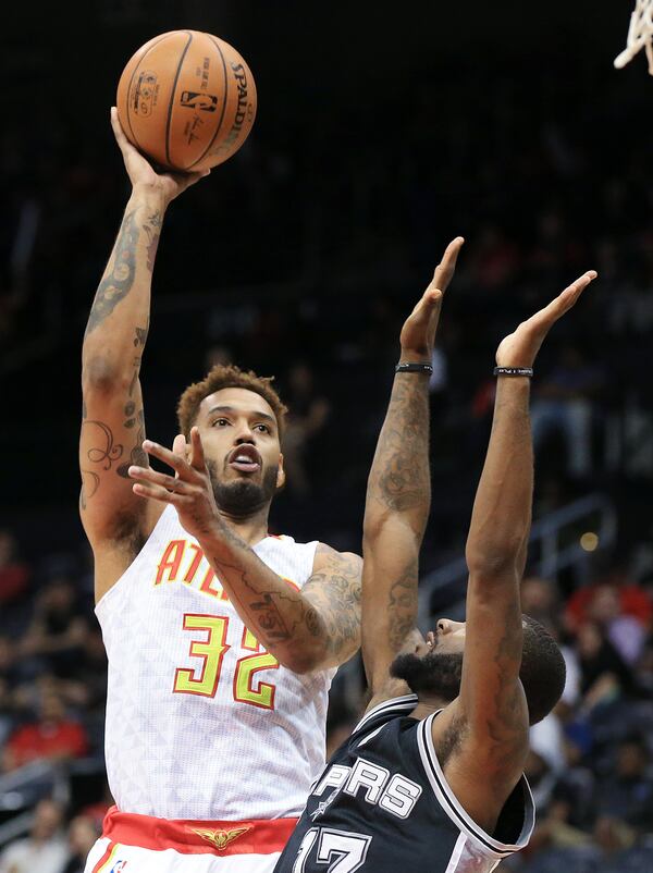 Mike Scott shoots for two over an opponent during a preseason game in 2015. Curtis Compton / ccompton@ajc.com