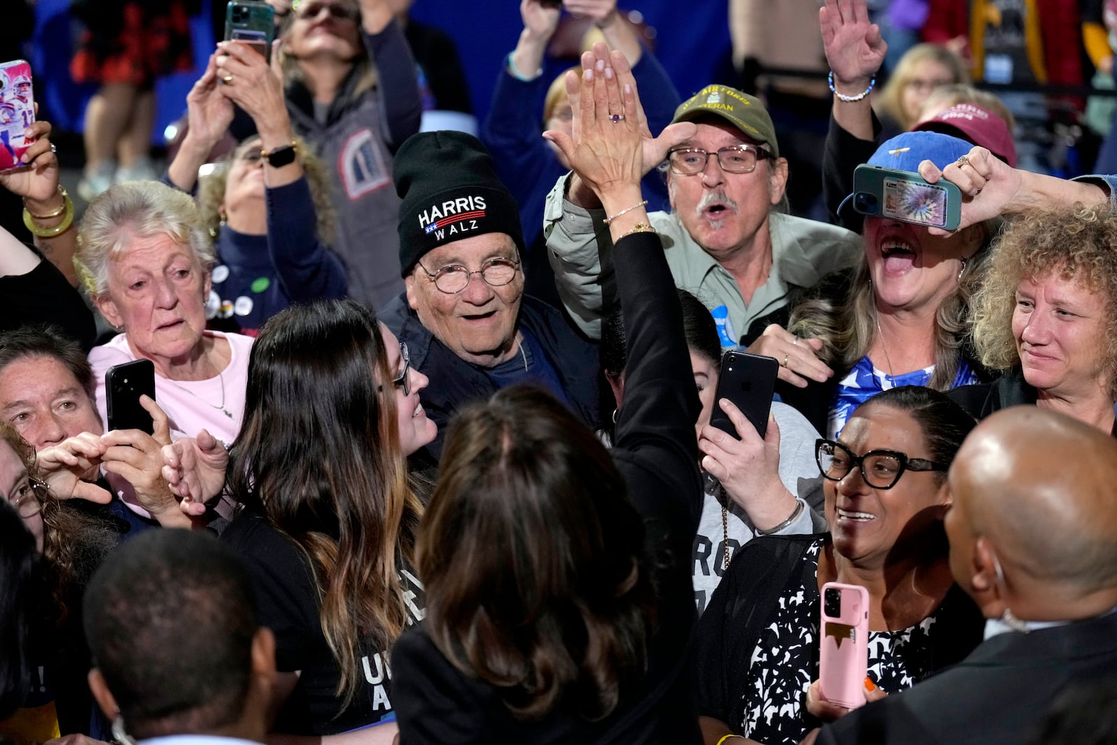 Democratic presidential nominee Vice President Kamala Harris, bottom center, gives a high-five as she greets supporters at a campaign rally at Erie Insurance Arena, in Erie, Pa., Monday, Oct. 14, 2024. (AP Photo/Jacquelyn Martin)