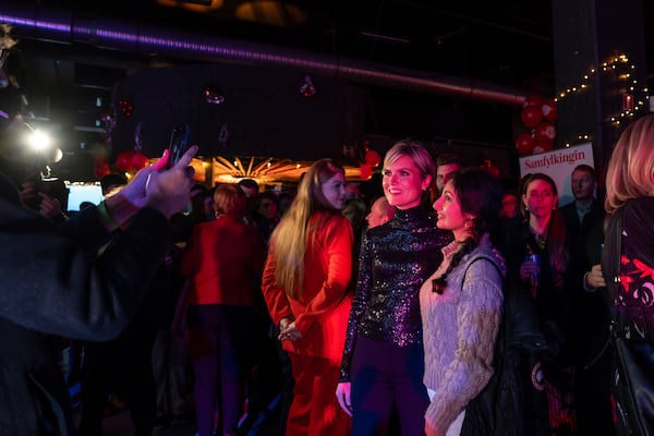 Kristrún Mjöll Frostadóttir, left, leader of the Samfylking, Social Democratic party, poses for a photo with a supporter at the celebration party following the closure of the polling stations in Reykjavik, Saturday Nov. 30, 2024. (AP Photo/Marco di Marco)