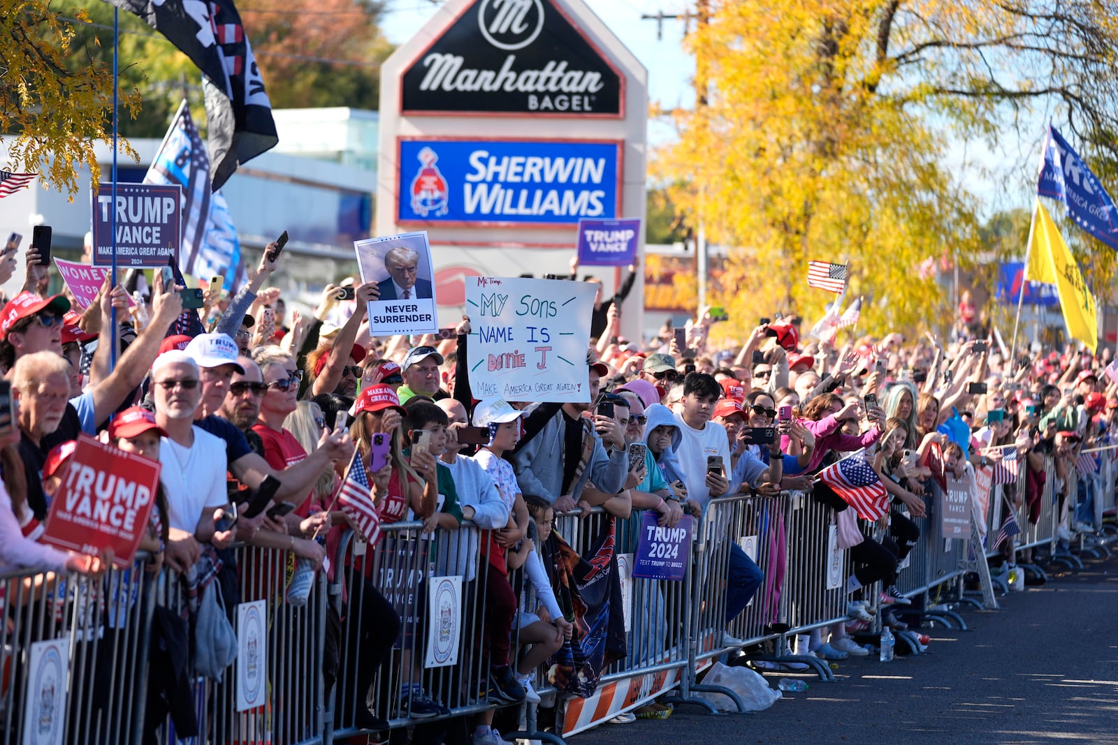 Supporters of Republican presidential nominee former President Donald Trump cheer outside of a McDonald's in Feasterville-Trevose, Pa., after Trump made a campaign stop, Sunday, Oct. 20, 2024, (AP Photo/Evan Vucci)