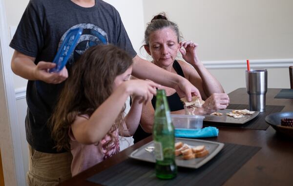 Alicia Hornsby eats lunch with her two children at their Canton home. Ben Gray for the Atlanta Journal-Constitution