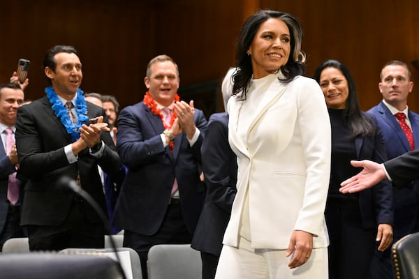 Former Hawaii U.S. Rep. Tulsi Gabbard was greeted by well wishers before a Senate committee hearing in Washington.