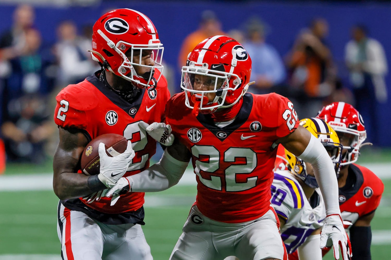 Georgia Bulldogs linebacker Smael Mondon Jr. (2) recovers a deflected LSU Tigers pass with defensive back Javon Bullard (22) during the first half of the SEC Championship Game at Mercedes-Benz Stadium in Atlanta on Saturday, Dec. 3, 2022. (Bob Andres / Bob Andres for the Atlanta Constitution)