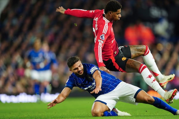 Ipswich Town's Sam Morsy, bottom, tackles Manchester United's Marcus Rashford during the English Premier League soccer match between Ipswich Town and Manchester United at Portman Road stadium in Ipswich, England, Sunday, Nov. 24, 2024. (AP Photo/Dave Shopland)