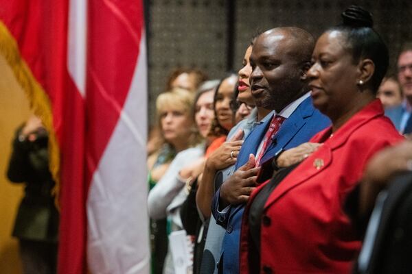 Atlanta Superintendent Bryan Johnson (left) and interim Superintendent Danielle Battle recite the Pledge of Allegiance during his swearing-in ceremony in Atlanta on Monday, Aug. 5, 2024.  (Ziyu Julian Zhu / AJC)