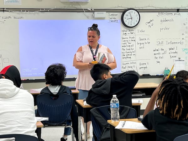 Jennifer Dallas reads a book with her fifth grade class at Heards Ferry Elementary School in Fulton County. She's teaching them to make inferences using a book called "The Broken Bike Boy and the Queen of 33rd Street." (Martha Dalton/martha.dalton@ajc.com)