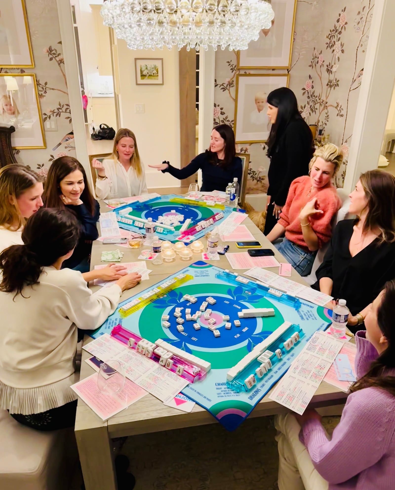 The founders of the Buckhead Mahjong Club, Liz Liu (top right) and Luci Holbert (bottom right) and friends enjoy a game of mahjong. 
(Courtesy of Buckhead Mahjong Club)