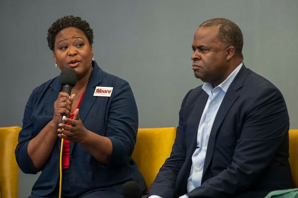 10/01/2021 — Atlanta, Georgia — Atlanta mayoral candidate Kasim Reed listens as candidate Felicia Moore speaks during a forum hosted by Partners for HOME and Policing Alternatives & Diversion Initiative at the Institute of Technology Hotel and Conference Center in Atlanta, Friday, October 1, 2021.  (Alyssa Pointer/Atlanta Journal Constitution)