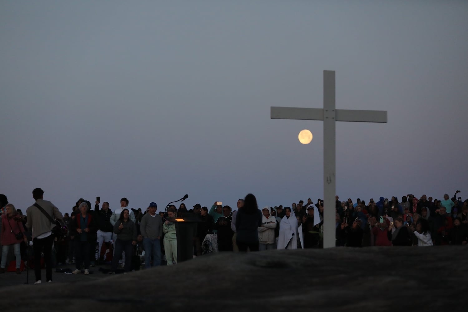 People crowd around the cross at the top of Stone Mountain during the 76th annual Easter Sunrise Service on Sunday, April 17, 2022. Miguel Martinez/miguel.martinezjimenez@ajc.com