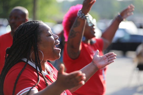 Sareeca Huslcins prays as she listens to a faith leader's speech Thursday night.