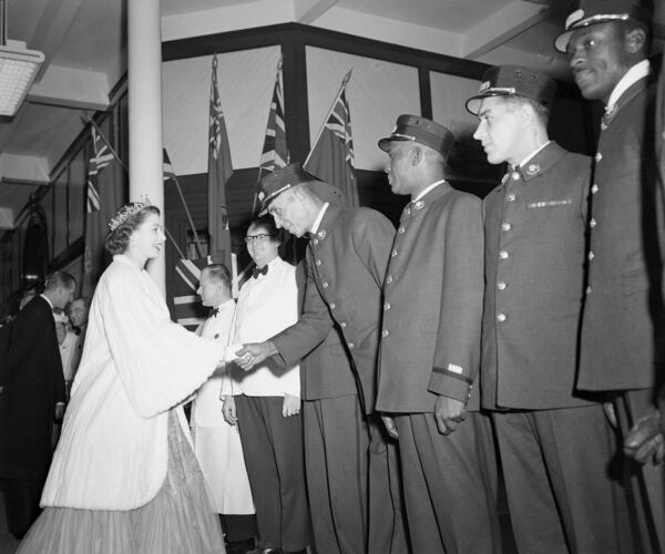 Princess Elizabeth thanks Pullman porter Noel Mapp of Montreal, as other porters from the Royal Train form a line at Charlottetown, Canada, Nov. 9, 1951.  The Princess was leaving the train to attend a government dinner given by the provincial officials in the Prince Edward Island town.  (AP Photo/J. Walter Green)