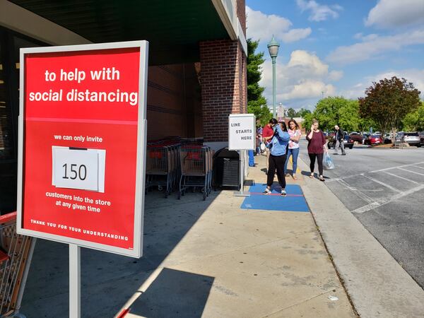 Metro Atlanta retailers have put new safety measures in place during the coronavirus pandemic, including some to comply with executive orders issued by Georgia Gov. Brian Kemp. Shoppers had to wait outside a T.J. Maxx store in Gwinnett County to avoid exceeding limits on how many people were allowed to be inside at one time. MATT KEMPNER / AJC