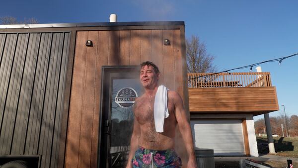 Jeff Tait, of Hastings, Minn. ,cools off after a session in a Saunable mobile sauna at Lebanon Hills Regional Park in Eagan, Minn., Sunday, Dec. 1, 2024. (AP photo/Mark Vancleave)