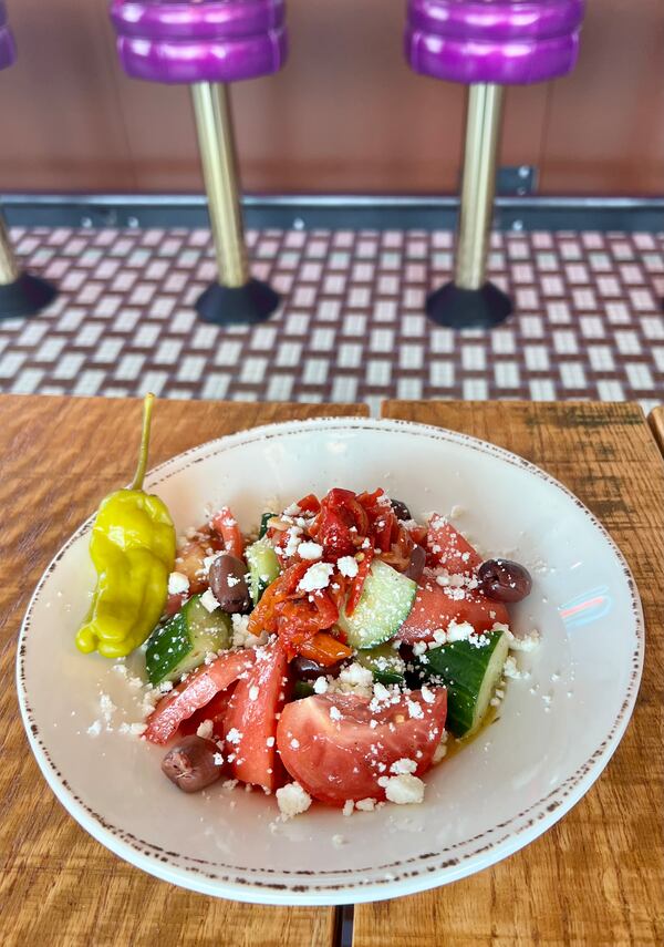 The Greek salad at Bona Fide Deluxe includes tomato, cucumber, kalamata olive, pickled onions, peperonata and feta. Courtesy of Katie McDonald