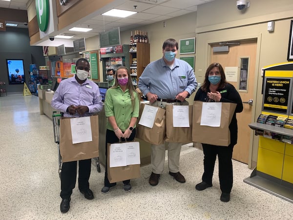 Employees of the Publix at Johnson Ferry and Ashford-Dunwoody roads in Brookhaven accept 90 rice bowls from Verde Taqueria. The meals were donated to support essential workers during the pandemic. Courtesy of Matt Gunter