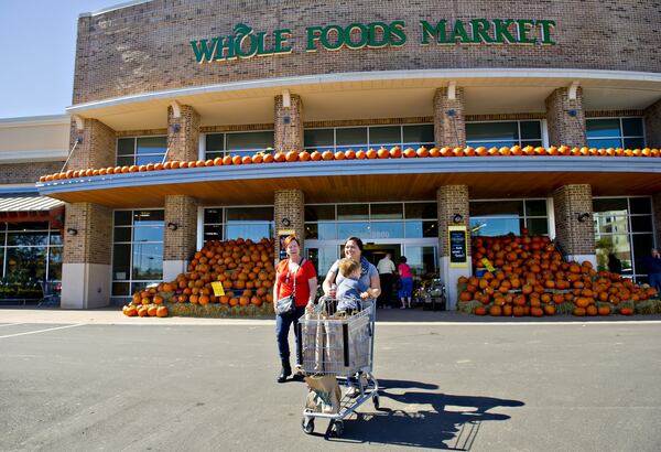 Shoppers leave a Whole Foods Market at the Avalon development in Alpharetta in 2014. Mark Toro, a real estate executive whose company developed Avalon, called Amazon’s purchase of the grocer “a validation of bricks and mortar retail.” JONATHAN PHILLIPS / SPECIAL