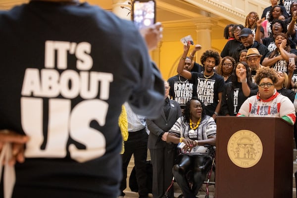 Kimberlyn Carter (right), executive director of Rep GA, speaks at a Black Voters Matter news conference at the Capitol in Atlanta last month.