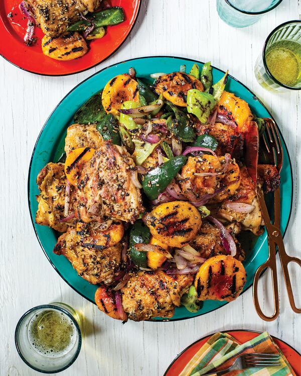 The flavors of a Southern summer meld with the sweetness and spice of India in Grilled Chicken Thighs with Peaches, Chiles, and Spiced Honey. Photo reprinted from "I Am From Here: Stories and Recipes From a Southern Chef" by Vishwesh Bhatt (Norton, $37.50). (Courtesy of Angie Mosier)