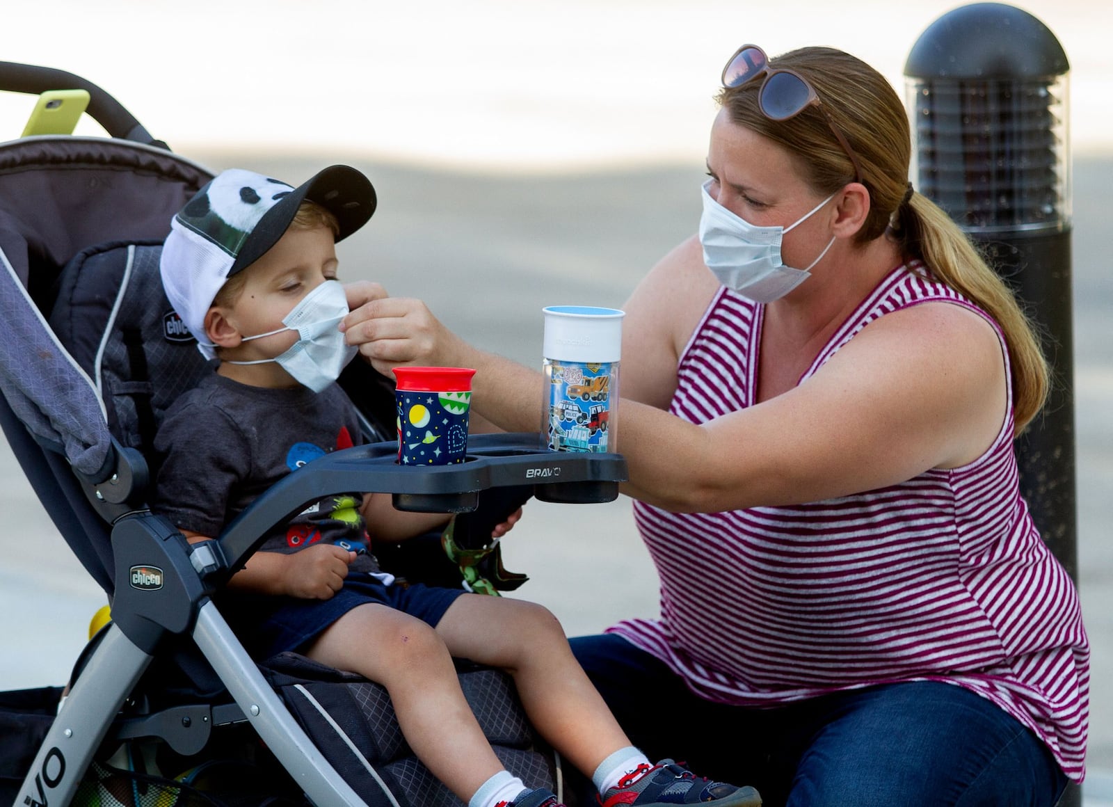 Marlie Arnold helps her son Lucas with his mask before entering Zoo Atlanta on Saturday, May 16, 2020. STEVE SCHAEFER FOR THE ATLANTA JOURNAL-CONSTITUTION