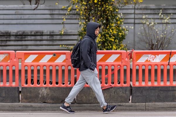 A man walks quickly along 5th Street amid colder temperatures in downtown Atlanta, Georgia. Thursday, March 20, 2025 (Ben Hendren for the Atlanta Journal-Constituiton)