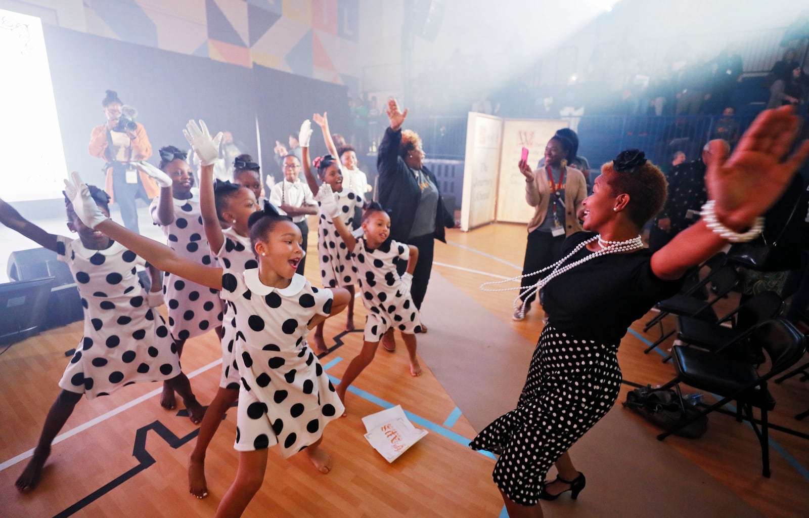 Lisa Perrymond, who took over the dance classes in October, dances with her students after they performed at the State of the District address at the newly renovated Harper-Archer Elementary School.  Bob Andres / robert.andres@ajc.com