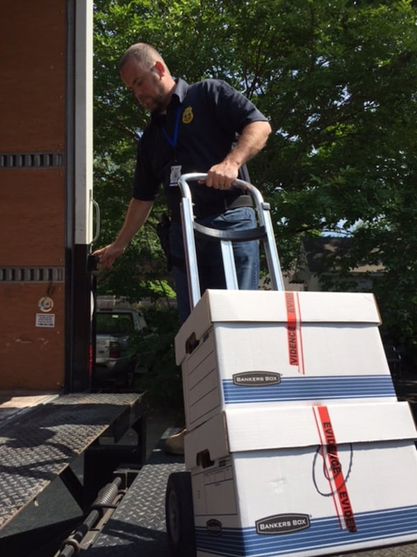 Georgia Department of Revenue’s chief investigator Josh Waites, seen here loading boxes of evidence from Hapeville tax preparers office, resigned while under investigation for falsifying his resume. The office Waites led is also being investigated by the Inspector General for how it spent assets seized from investigations.