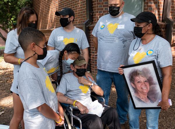 Louis Pabon (center), who lost his wife, Miriam, to COVID-19, attends a National COVID Awareness Day event with his family Saturday morning, August 7, 2021, at St. Luke’s Episcopal Church in Atlanta. (Photo: Ben Gray for The Atlanta Journal-Constitution)