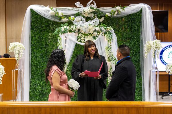 Fulton County Chief Probate Judge Kenya Johnson performs a marriage ceremony for Teresa Garcia and Jesus Amaro at the Fulton County Courthouse in Atlanta on Valentine’s Day, Tuesday, February 14, 2023. (Arvin Temkar / arvin.temkar@ajc.com)