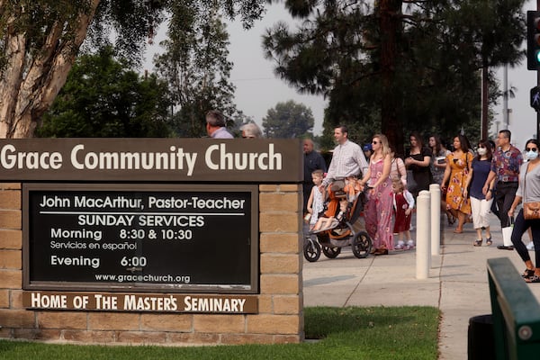 Grace Community Church parishioners make their way to Sunday service in Sun Valley, California, on September 13, 2020. The church held a packed morning service, defying a court order directing them to refrain from holding indoor services due to the COVID-19 pandemic. (Genaro Molina/Los Angeles Times/TNS)