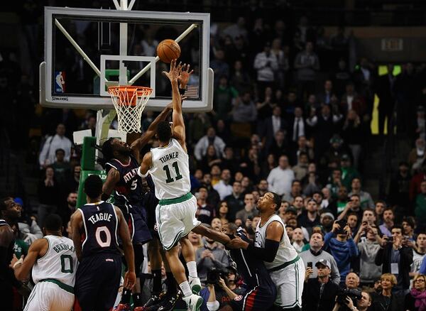 Boston Celtics Evan Turner (11) shoots the game winning basket over Atlanta Hawks DeMarre Carroll (5) with .2 seconds left on the clock in the second half of an NBA basketball game, Wednesday, Feb. 11, 2015, in Boston. The Celtics won 89-88. (AP Photo/Jessica Hill) Give Evan Turner credit. DeMarre Carroll made him make a tough shot. (AP photo/Jessica Hill)