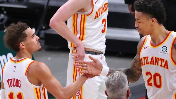 Hawks Trae Young and John Collins celebrate beating the Milwaukee Bucks in Game 1 of the Eastern Conference finals Wednesday, June 23, 2021, in Milwaukee. (Curtis Compton / Curtis.Compton@ajc.com)