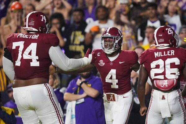 Alabama quarterback Jalen Milroe (4) celebrates his touchdown carry with Alabama offensive lineman Kadyn Proctor (74) in the first half an NCAA college football game against LSU in Baton Rouge, La., Saturday, Nov. 9, 2024. (AP Photo/Gerald Herbert)